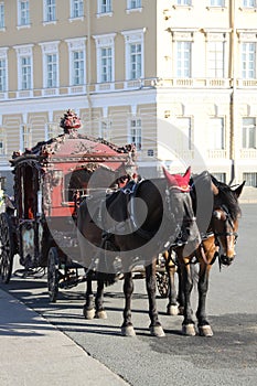 Two horses and red carriage