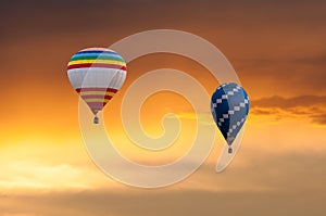 Two Hot Air Balloons in Flight on sunset sky