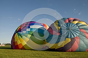 Two hot air balloons inflating on the ground