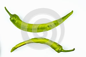 Two hot green peppers isolated on a white background