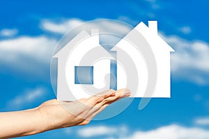 Two houses on the hand on blue sky