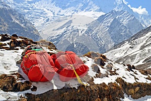 Two huge red backpacks for mountain expedition on snow. Porter Mountaineering equipment.