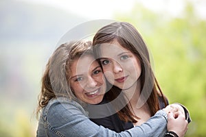 Two hugging teenage girls