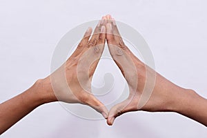 Two human hand gesturing triangle 