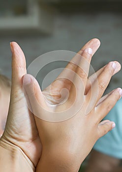 Two human hands of adult and child hold together