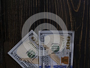 Two hundred dollars bills on a wooden background. new hundred dollar bill. Close up american dollar banknotes