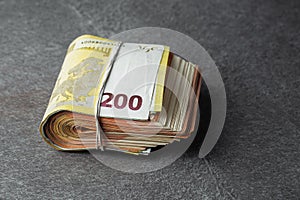 two hundred euro banknote in bundle or rubber band for money isolated on grey background. horizontal photo