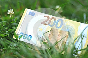 Two hundred euro banknote in the grass