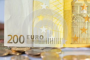 Two Hundred Euro Banknote on top of Coins. European Monetary Currency. European Central Bank Money