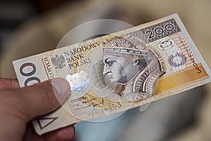 Two hundreds zloty banknote  in mans hand