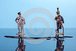 Two hussars from the Napoleonic Wars stand in front of a puddle of water