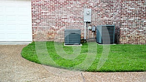 Two HVAC Air Conditioner systems next to home