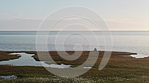 Two hydrologists wearing antimosquito screens on their heads examine ground and make measures. Descover Yamal peninsula.