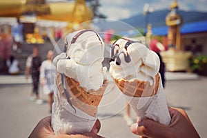 Two ice cream cones collide beautiful background.