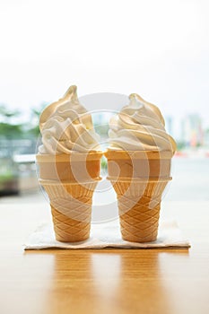 two ice cream cones on table vertical composition