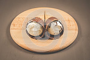 two ice cream on a round wooden support/two ice cream on a round wooden support on a dark background, selective focus