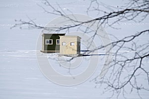 Two Ice Fishing Shacks on a Snow Covered Lake in New England