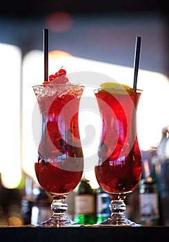 Two ice glasses with red alcoholic cocktail.