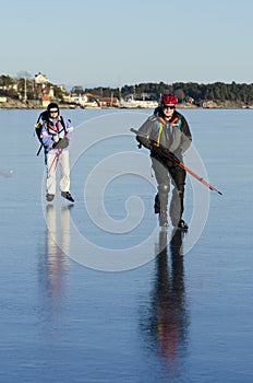 Two ice skaters on smoth ice