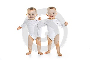 Two identical twins on a white isolated background