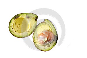 Two imperfect bruised avocado halves isolated on a white background with copy space