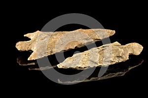 Two Indian arrowheads and black background