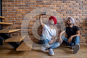 Two indian men in turbans making selfie