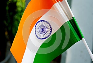 Two Indian national Tricolor flag holding in hand. Independence Day and Republic Day of India. Flying Indian Tiranga flag close-up