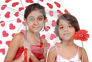 Two Indian sisters in red and white theme