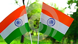 Two Indian tricolor national flags in nature background.