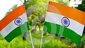 Two Indian tricolor national flags in nature background. Independence Day and Republic Day of India. 15 August Indian Tiranga