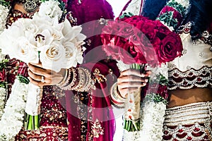 Two Indian Wedding Bouquets and brides photo