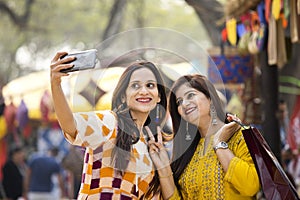 Two women taking selfie at Surajkund Mela photo