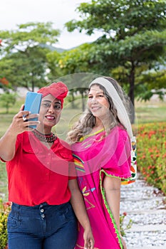 indigenou women taking a selfie in a park photo