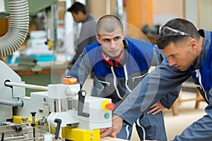 two industrial woodworking workers
