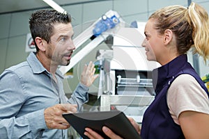 two industrial workers talking