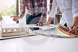 Two interior design or graphic designer at work on project of ar