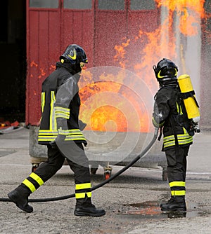 Two intrepid firefighters during the exercise with a tank full o