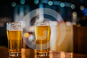 Two IPAs sitting on a table