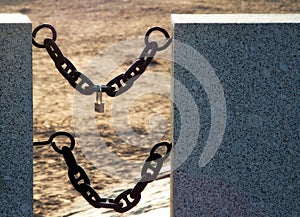 Two iron chains stretched between granit plates and a lock with