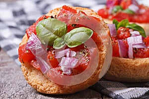 Two Italian bruschetta with tomato, onion and basil