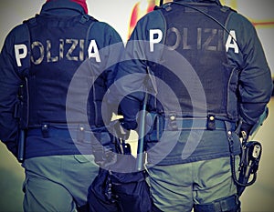 Two Italian cops with the words POLIZIA that means POLICE in Ita