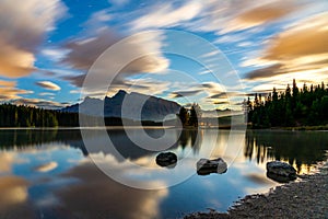 Two Jack Lake at daybreak  starry sky and colorful clouds reflected on the water surface