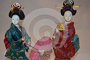 Japanese geisha doll with umbrella..and a fan.