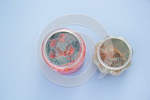 Two jars of slime on which mold appeared