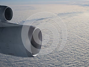 Two jet engines above cloud