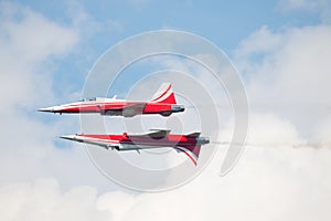 two jet fighters flying close upside down