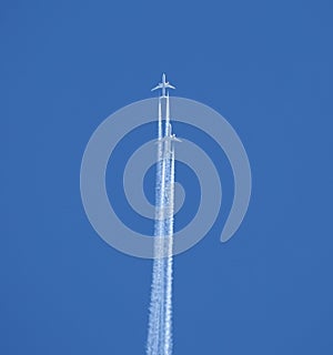 Two jet two-turbine aircraft in flight on blue sky background