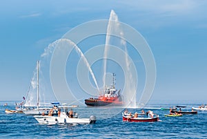 Fire brigade ship with high splashes to the sky