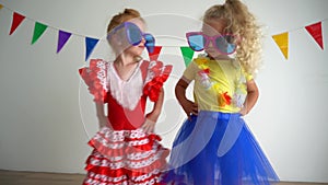 Two joyful funny children having fun and dancing at the party. Best friends girl